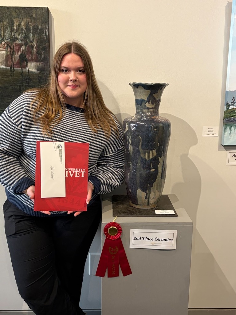 West Senior High art student holding her award winnings