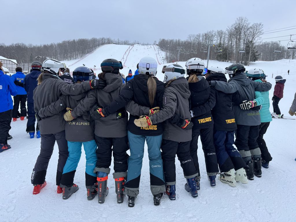 High School students standing together  arm and arm on the ski hill