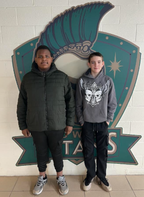 Kavontaye and Trevor standing in front of our Titan Logo