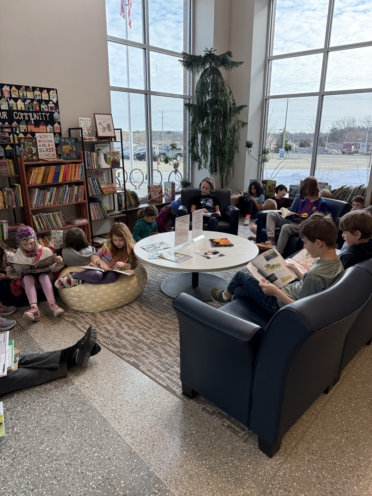 students sitting in the library reading books