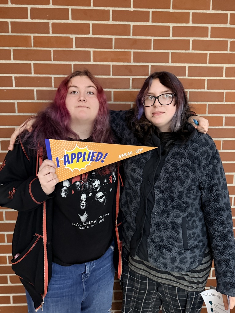 TCHS student holds up an "I applied" banner after applying at NMC.