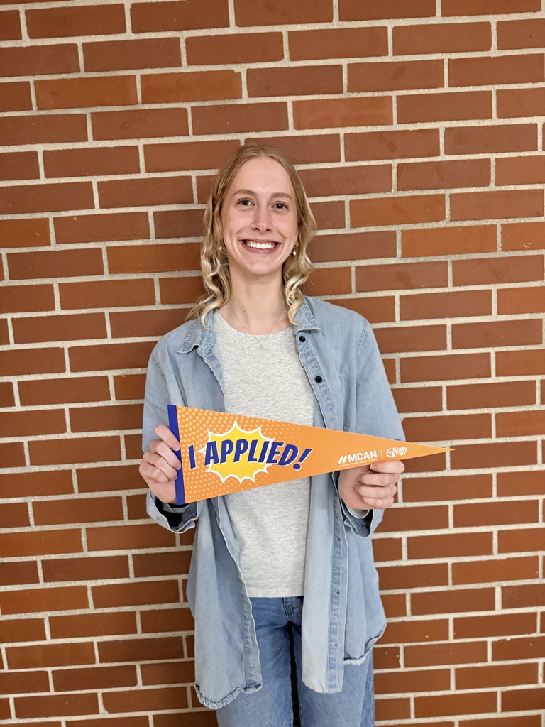 TCHS student holds up an "I applied" banner after applying at NMC.