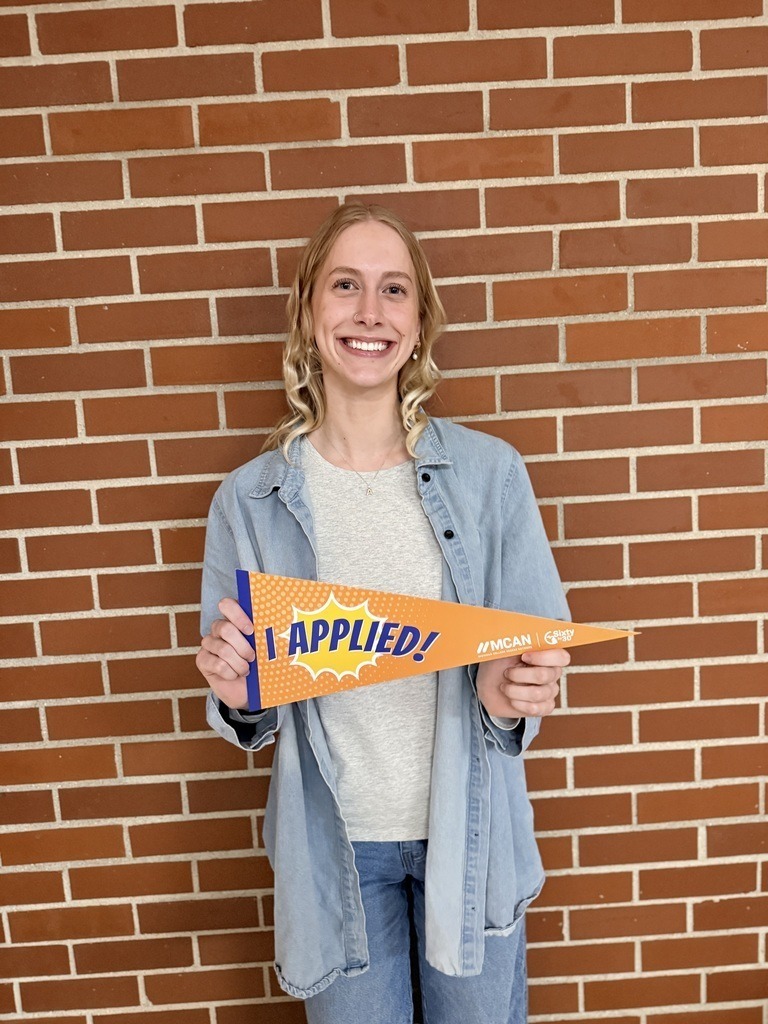 TCH student holding a banner that says I Applied