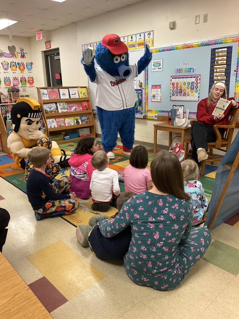 Mascots reading stories with kids.