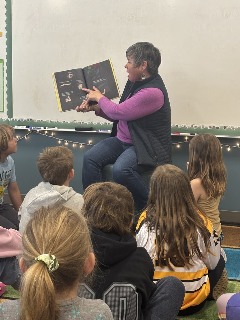 Rep. Coffia reading a story to 2nd grade students. 