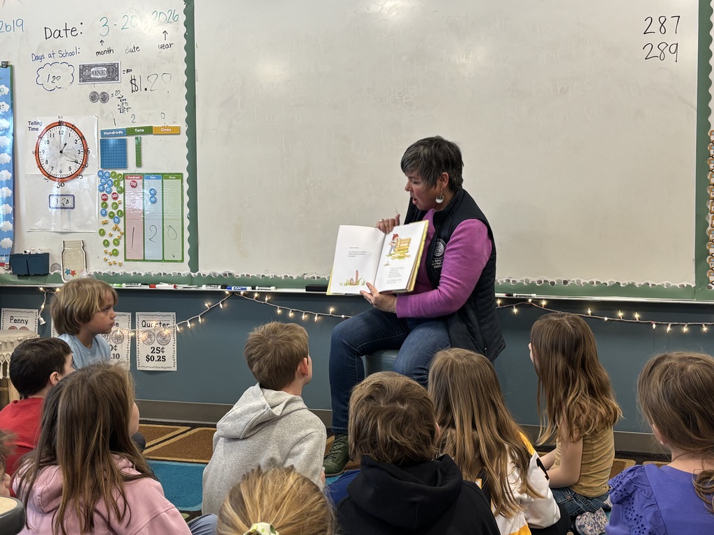 Rep. Coffia reading a story to 2nd grade students. 