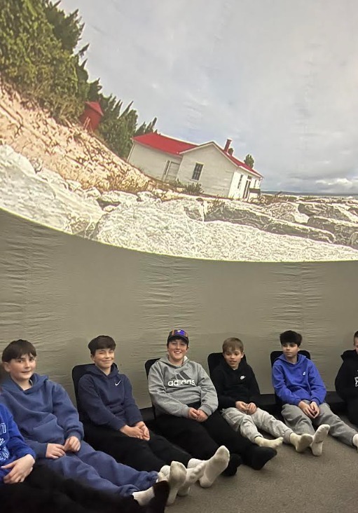 Students sitting underneath the interactive dome