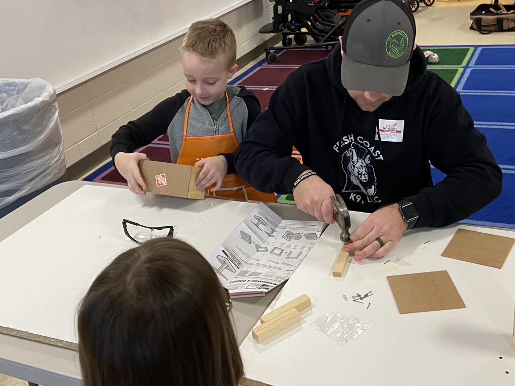 Volunteer doing crafts with students at a table