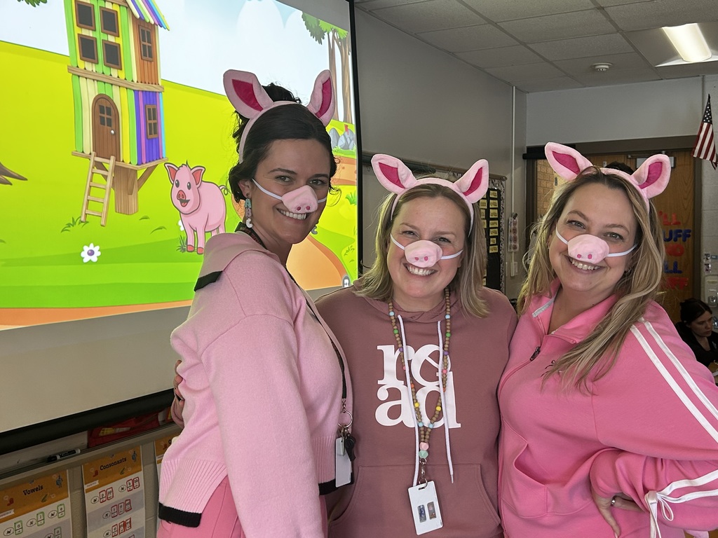 Three teachers dressed as the three little pigs.