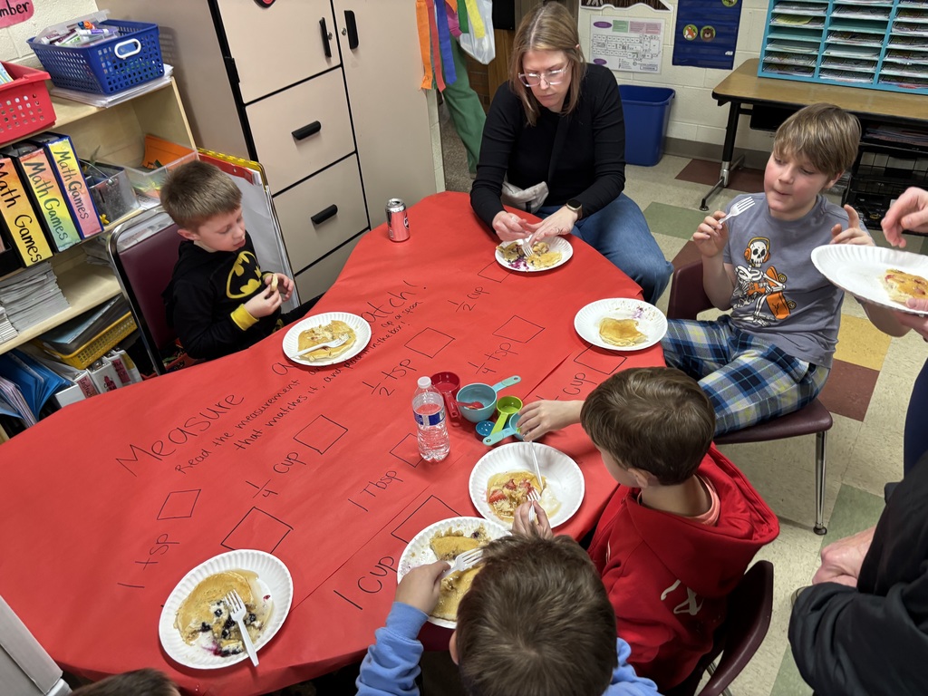Kids and moms eating pancakes.  