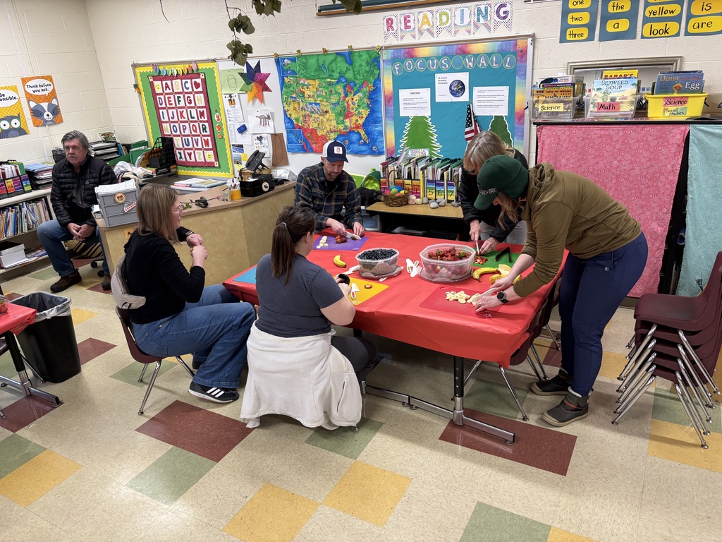 Parents cutting up fruit.  