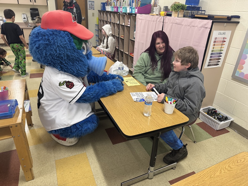 Monty from the Pit Spitters with a student and his mom.  