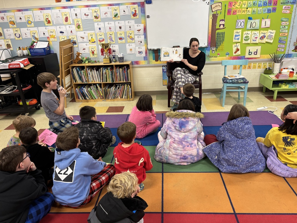Teacher reading a book to students.