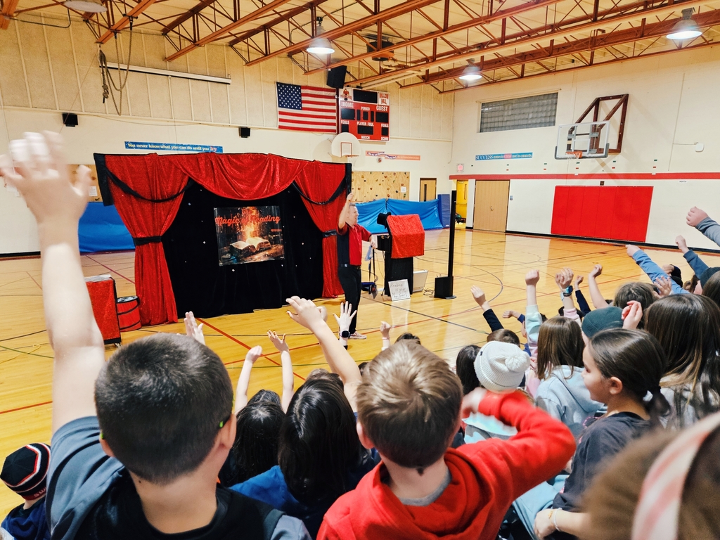 Students raising hands to volunteer during the show
