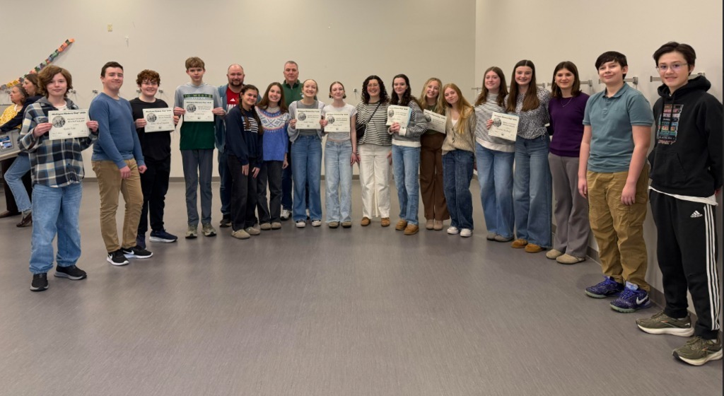 students standing together holding their certificates