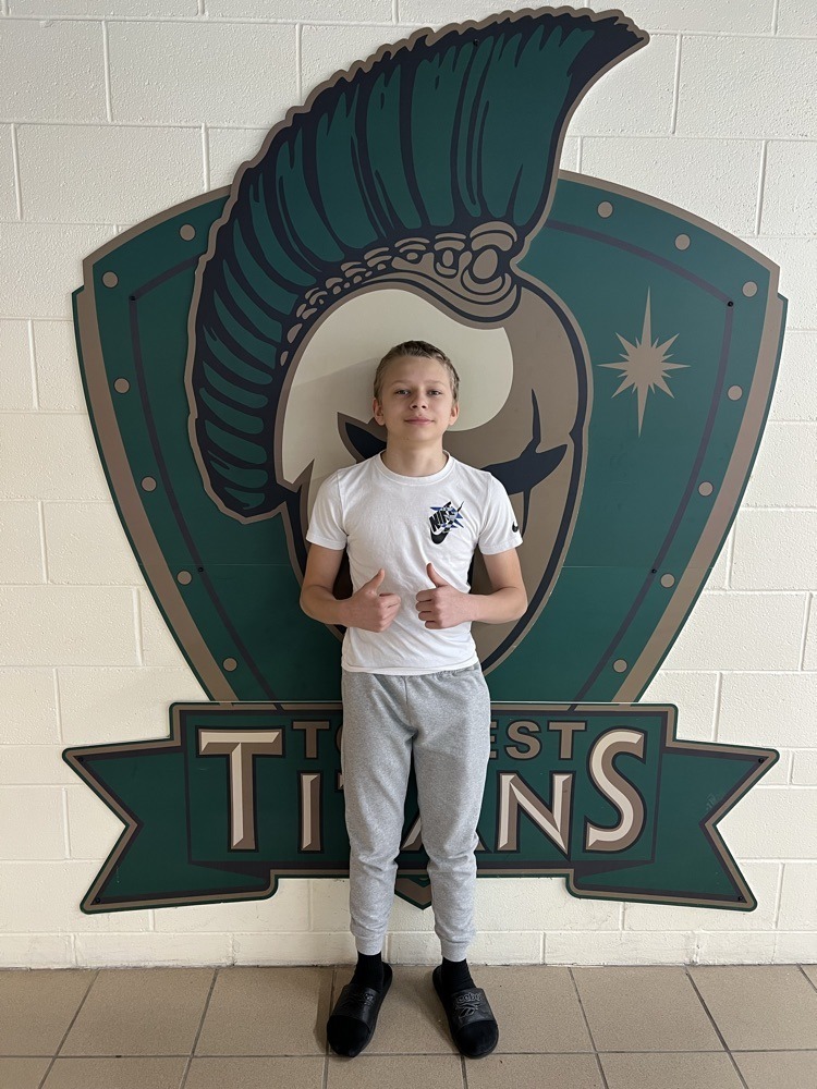 Student standing in front of the Titans wall mural.