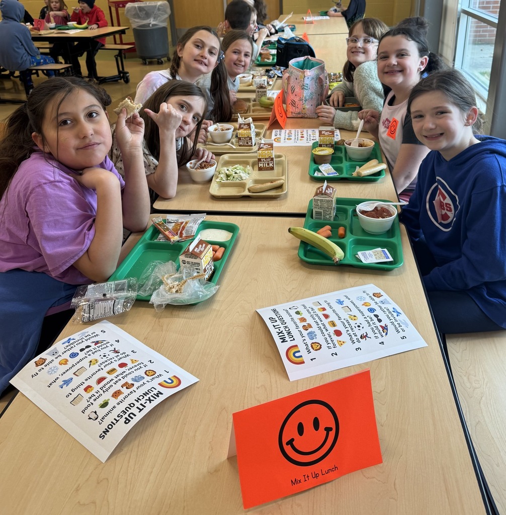 Students eating lunch together at the table.