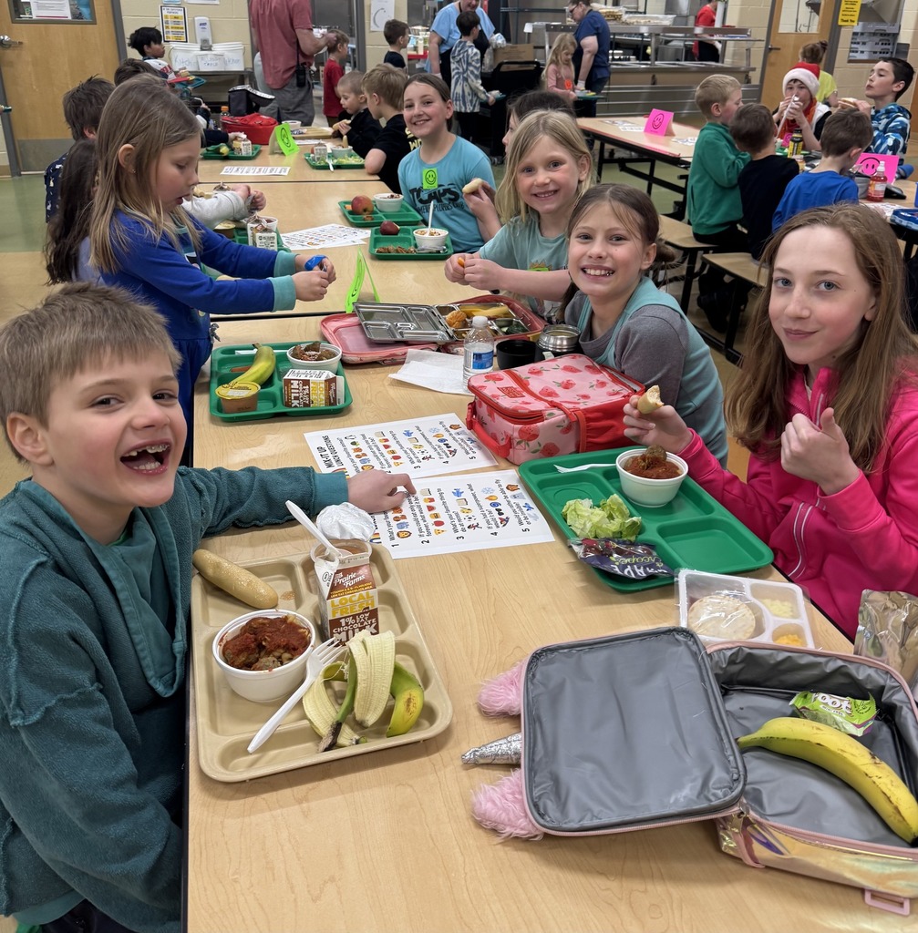 Students eating lunch together at the table.