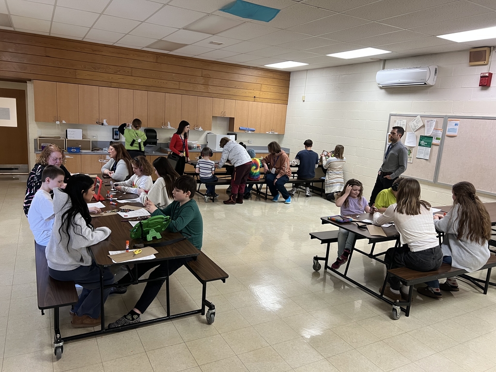 Peer to Peer mentors interacting at tables with other students