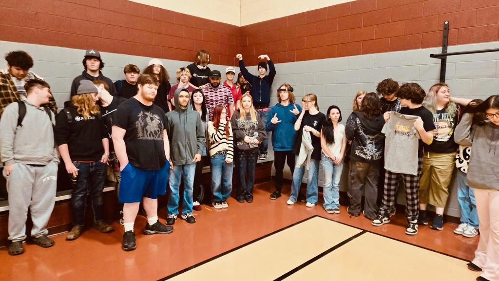 TCHS students gather around TCHS alumni for a group photo