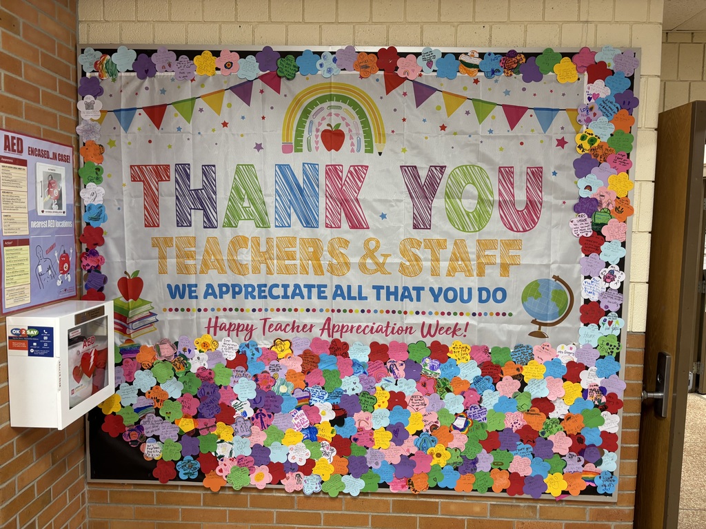 A wall displays a colorful banner with flowers, a rainbow, and the words "Thank You Teachers & Staff." It includes a white box and a door.