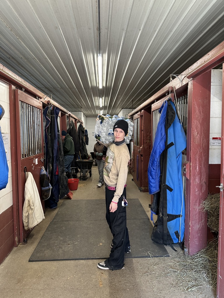 TCHS student carries water at Reining Liberty Ranch
