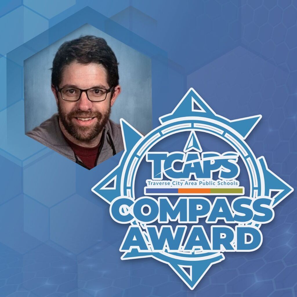 Man in glasses, smiling, over blue hexagon background with "TCAPS Compass Award" logo.