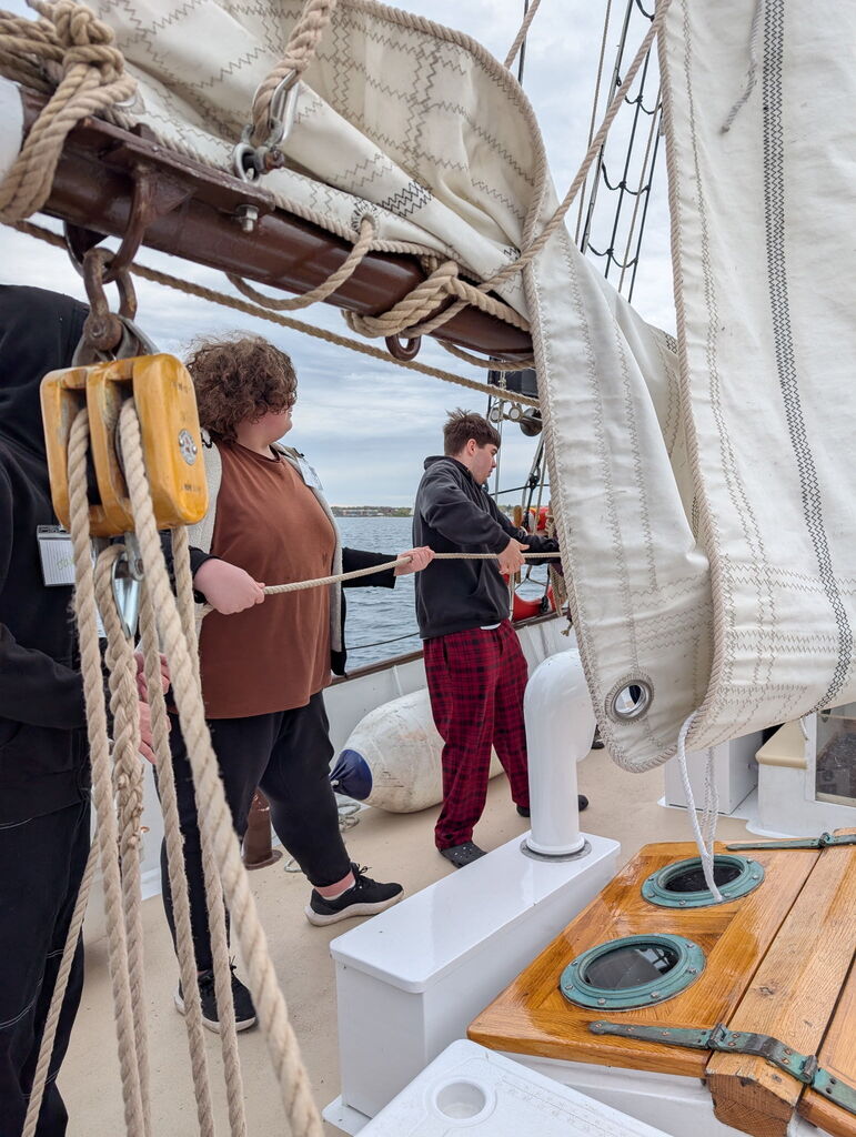 TCHS pull ropes on the Inland Seas sailboat