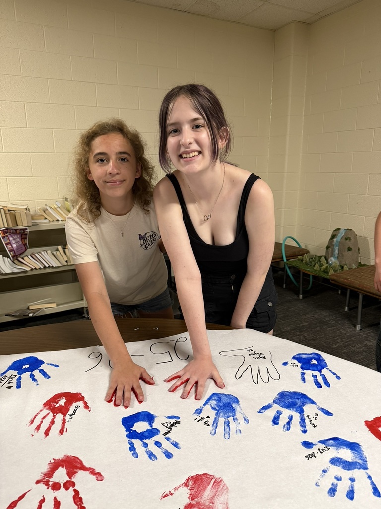 8th grade choir making their hand painted poster.