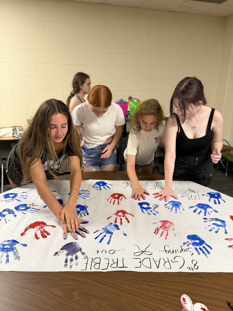 8th grade choir making their hand painted poster.