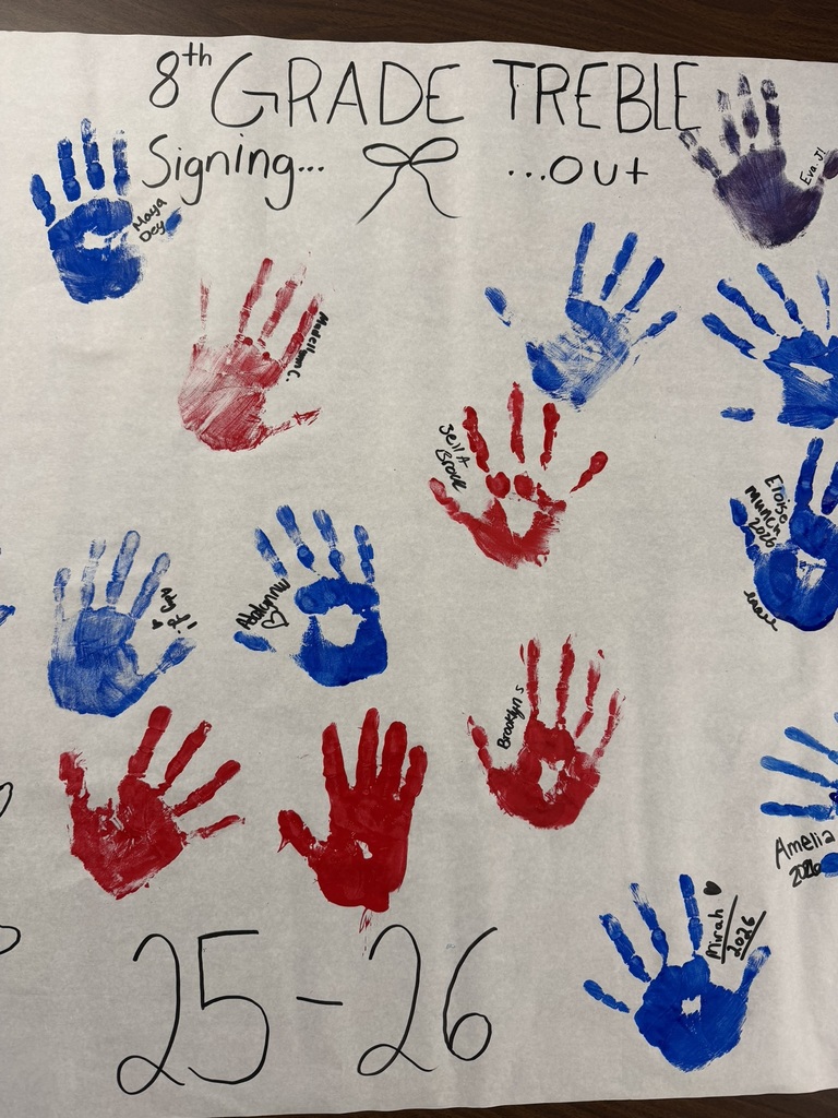 8th grade choir making their hand painted poster.