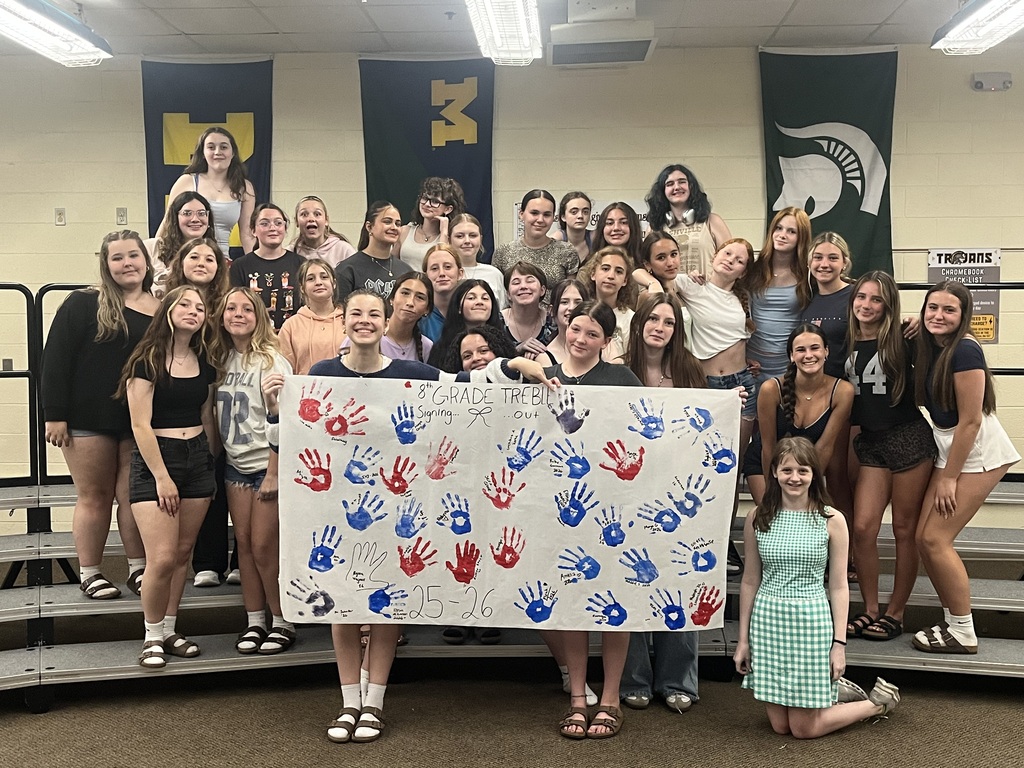 8th grade choir with their hand painted poster.