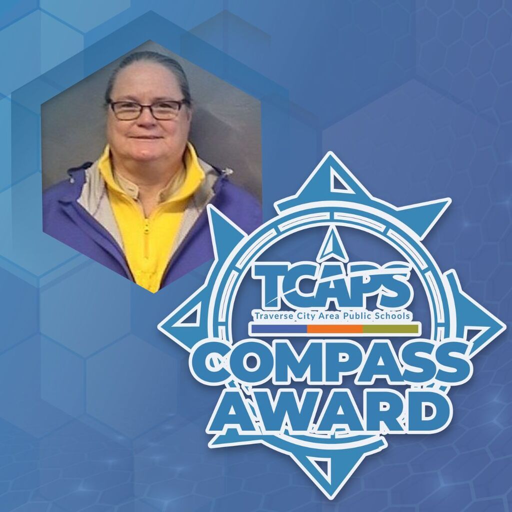 A person wearing glasses and a yellow shirt, set against a blue hexagonal background, with the "TCAP Compass Award" logo.
