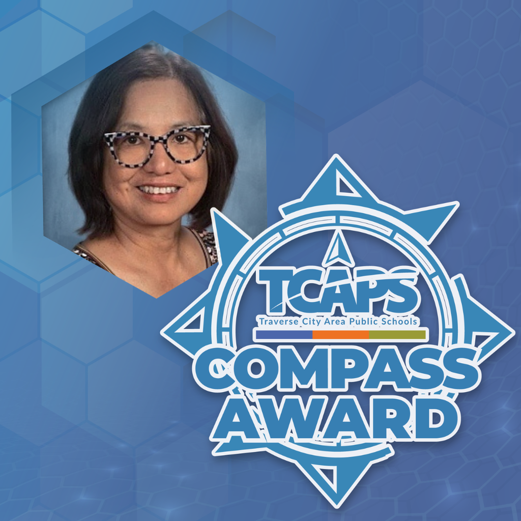 A woman with glasses and a smile is on the left. A hexagon is behind her. The text reads "TCAP's COMPASS AWARD" on a blue background.
