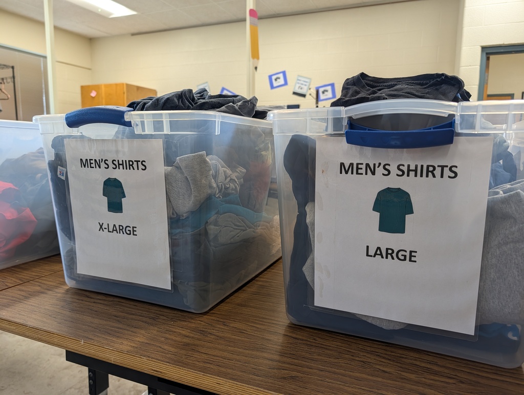 Two plastic containers with labels on a table. One reads "MEN'S SHIRTS X-LARGE" and the other "MEN'S SHIRTS LARGE".