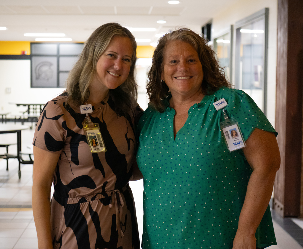 Staff members smiling for pictures at professional learning event.