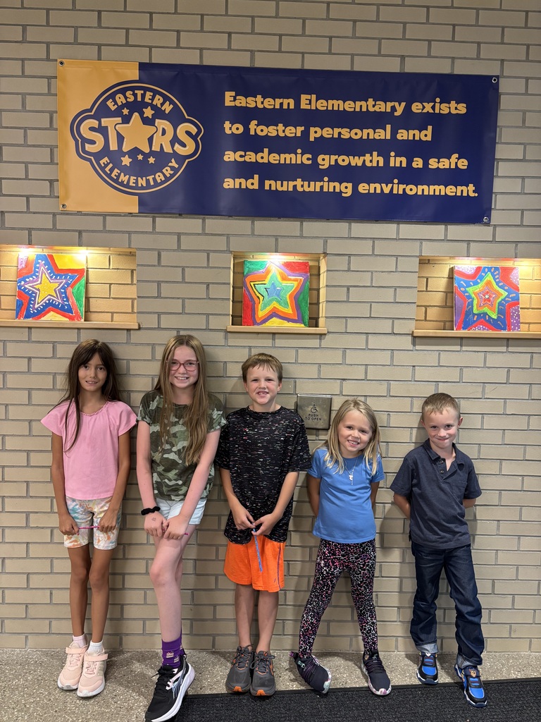 Group of students standing in front of the Eastern Stars sign