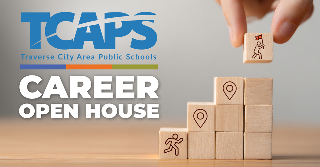 Hand placing a wooden block labeled "Career Open House" atop a stack. Logo for Traverse City Area Public Schools in the background.