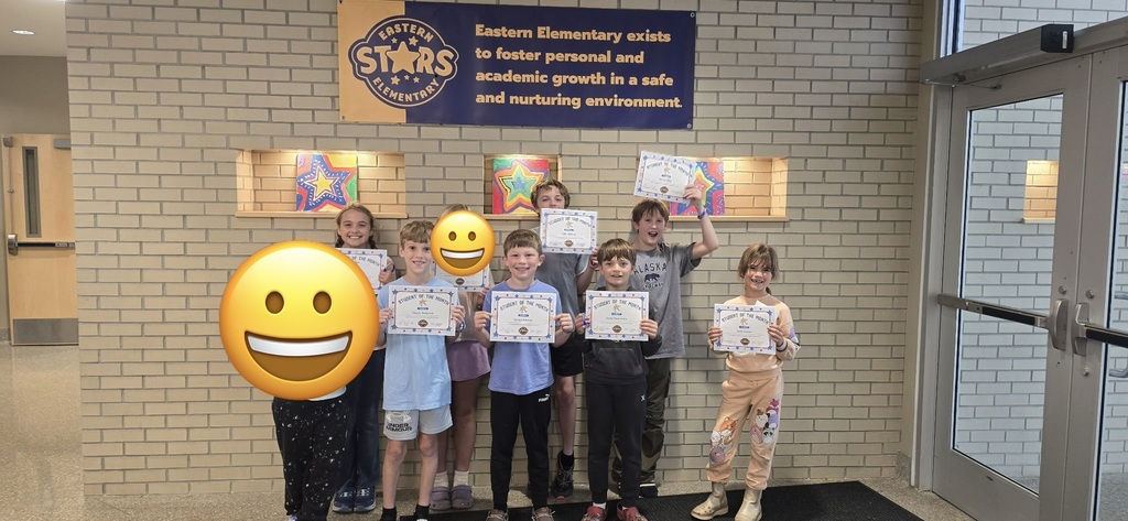 Group of students standing in front of the Eastern Stars sign