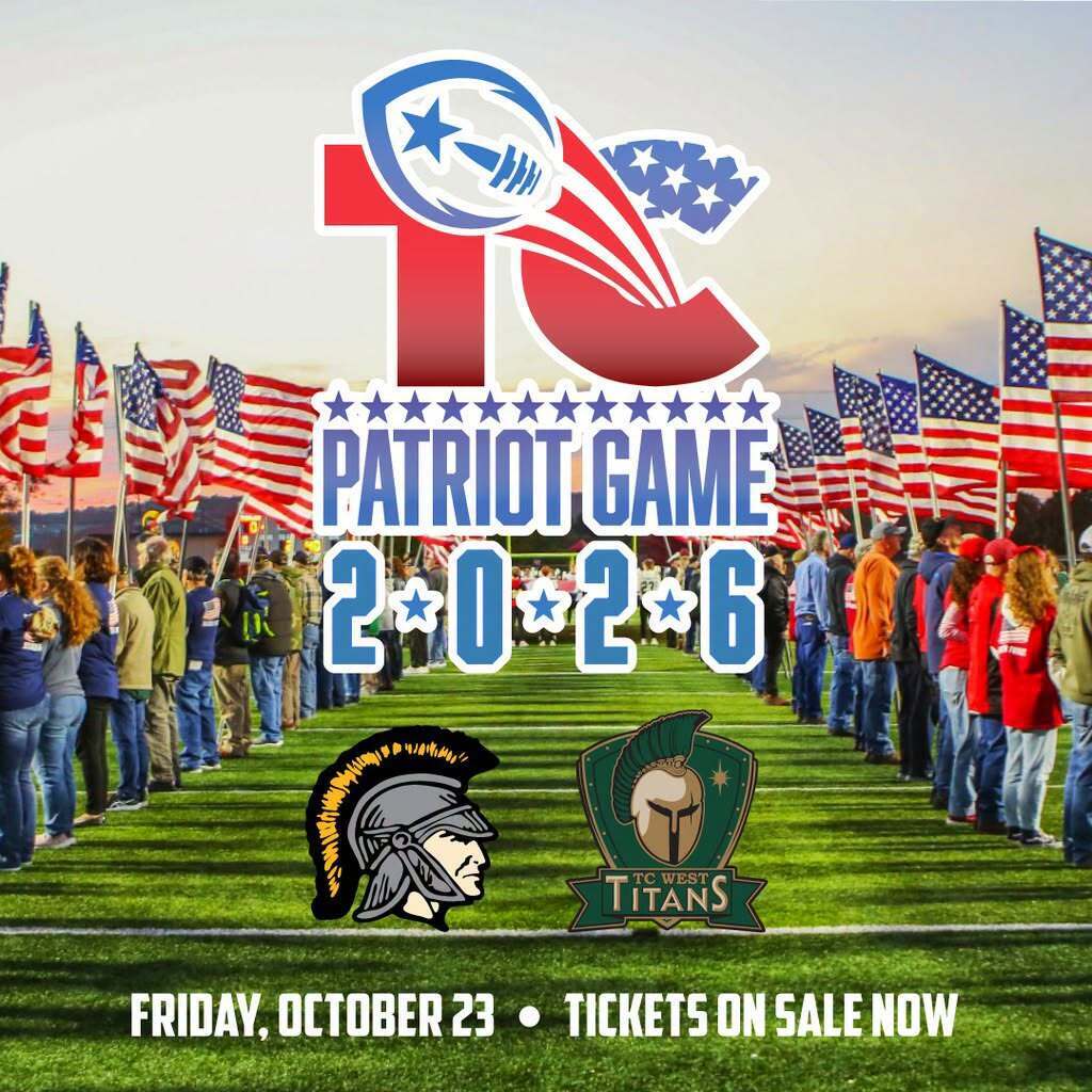 People stand in a line on a field with flags in the background. Logos of Trojans and Titans are present.