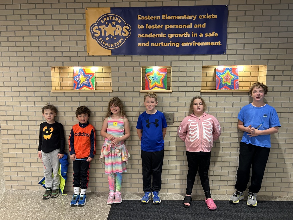 Group of students standing in front of the Eastern Stars sign