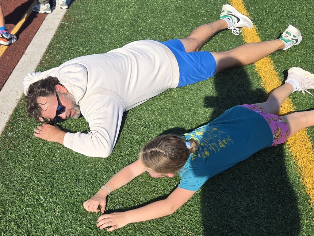 Mr. Swegles stretching on the ground after a long jog-a-thon run