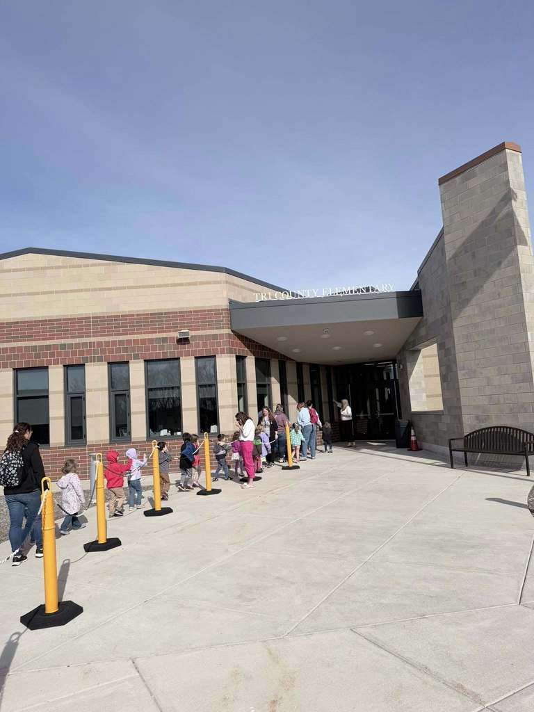 Preschool students lining up to enter the elementary school.