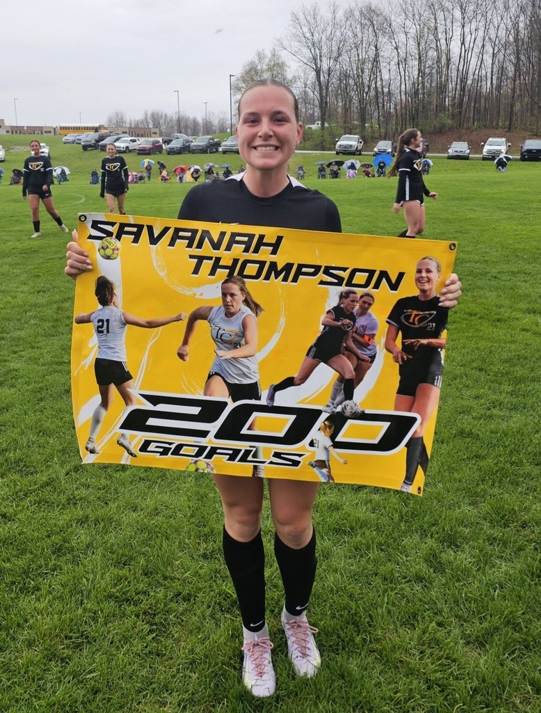 Athlete with their poster representing their 200th career goal.