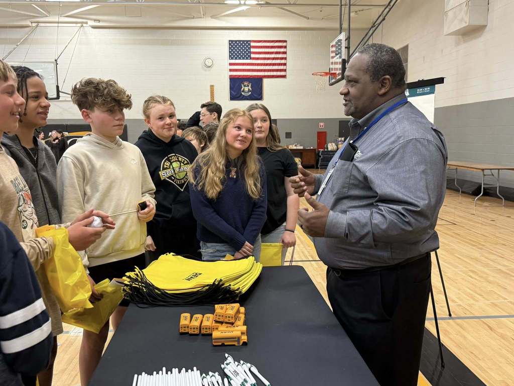 Students speaking with a representative from Dean's transportation