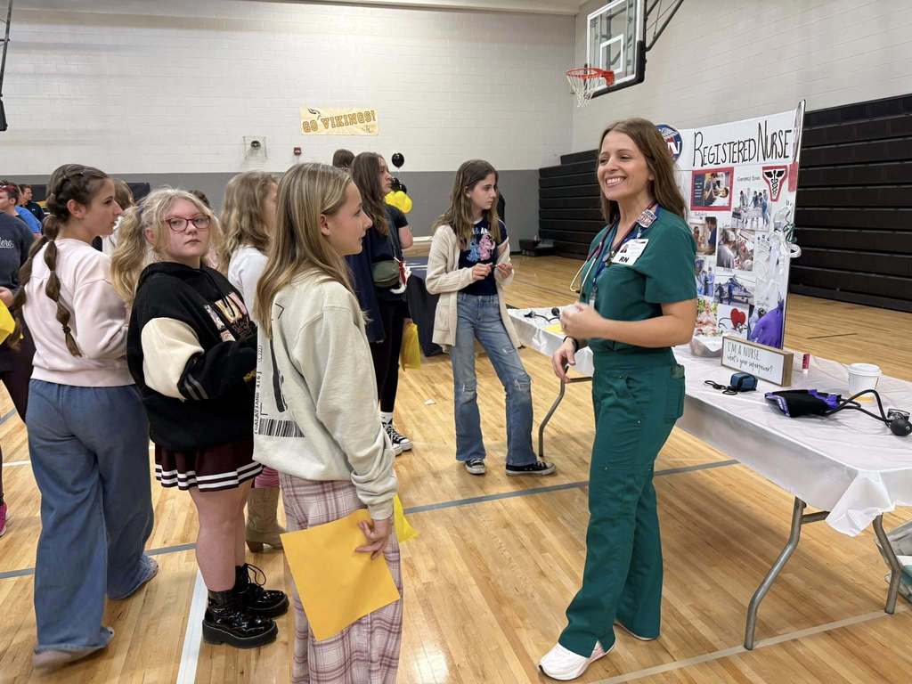 Students speaking with a nurse about possible careers