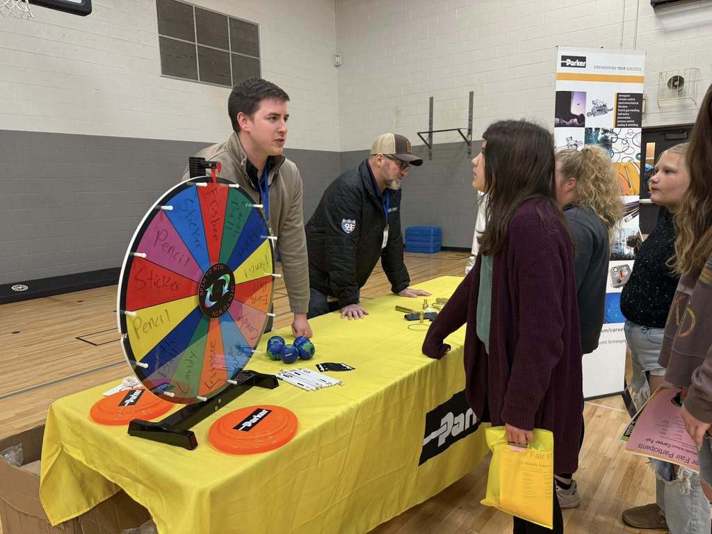 A student speaking with a representative on career day.