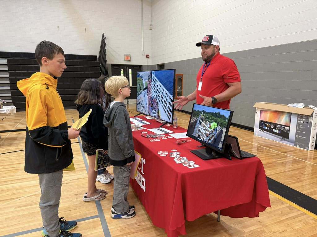 Students speaking with a representative what they do for a career