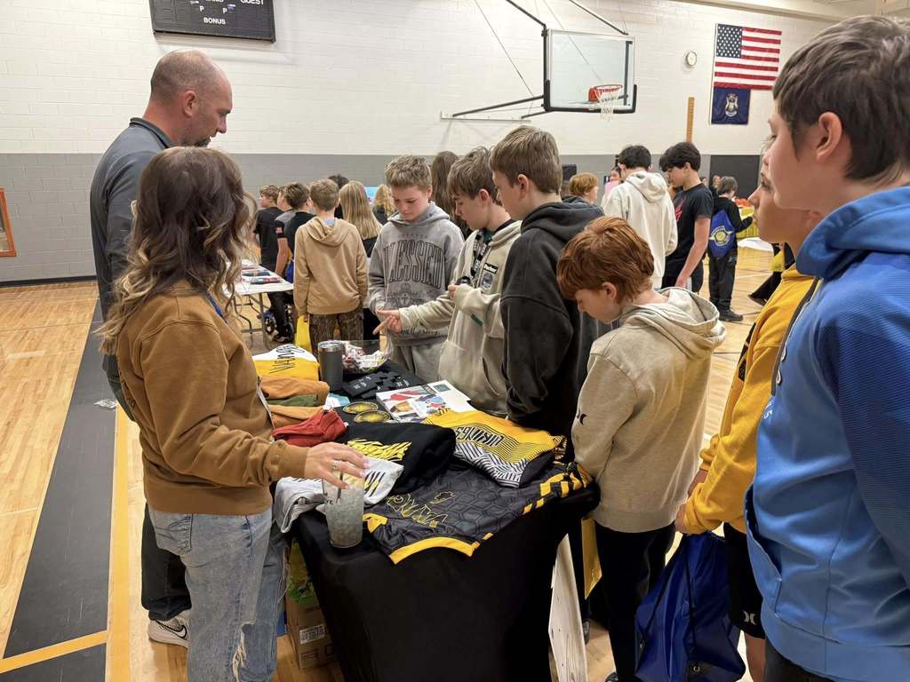 Students speaking with a local business about their career