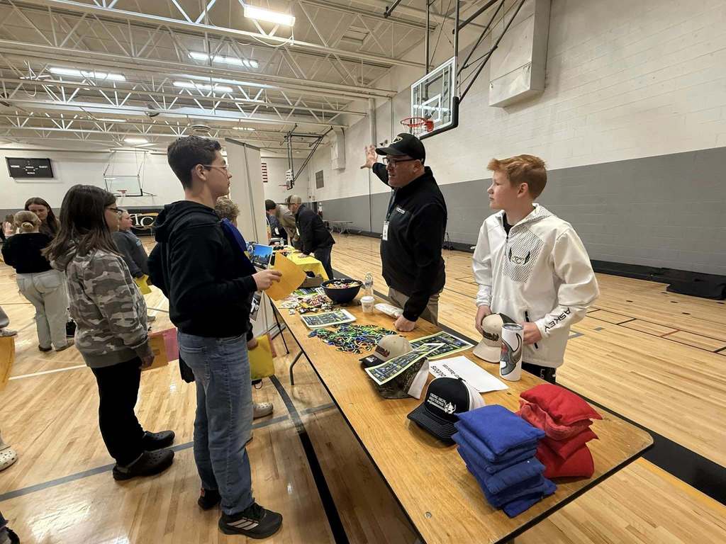 Students speaking with a local business about their career.